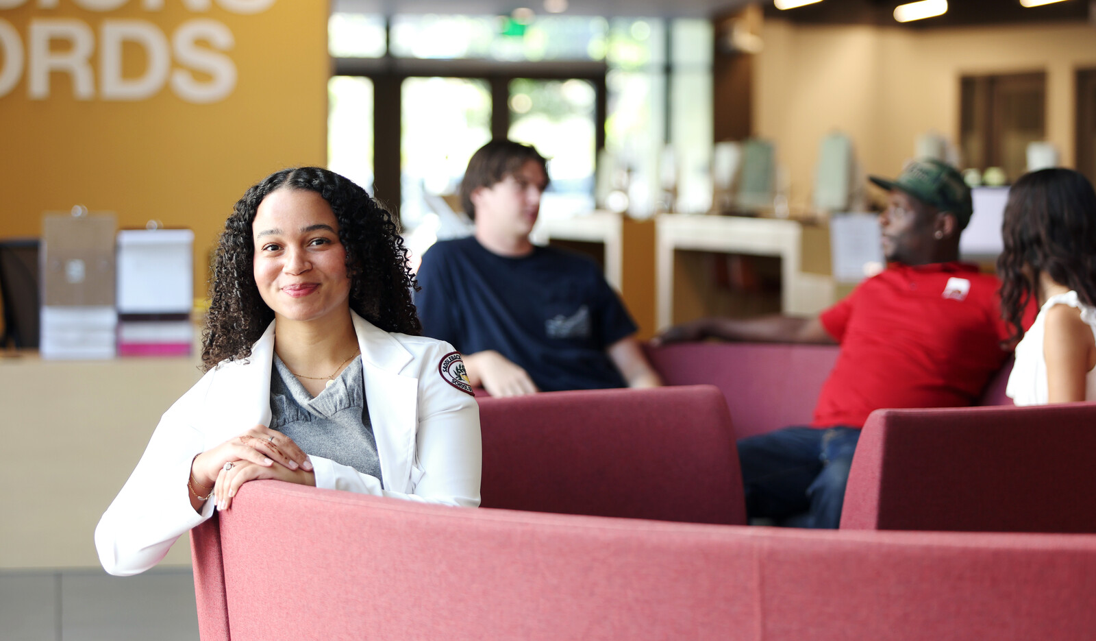students sitting together with one  featured in the front smiling