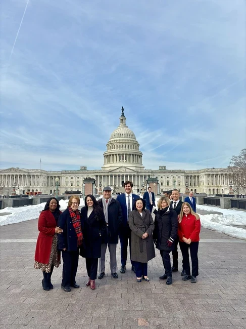 trustees standing in front of DC capitol