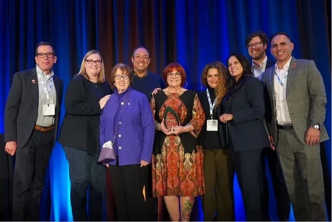 trustees standing with winner of award