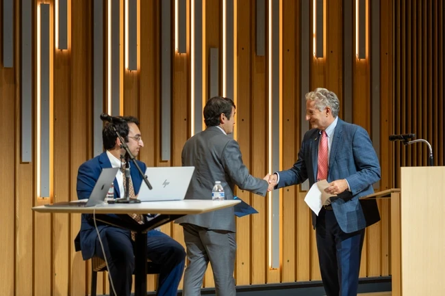 dave min and trustee tim jemal shaking hands at town hall