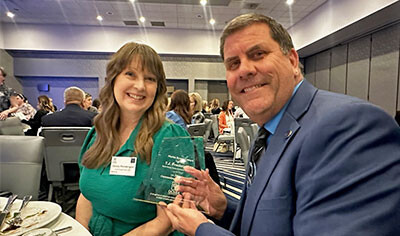 TJ Prendergast holding an award